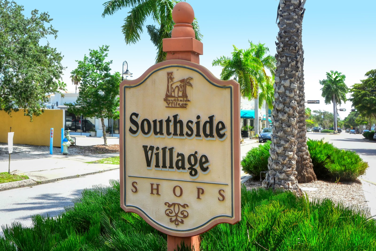 Southside Village Shops sign among palms on S Osprey Avenue in Sarasota's West of Trail district