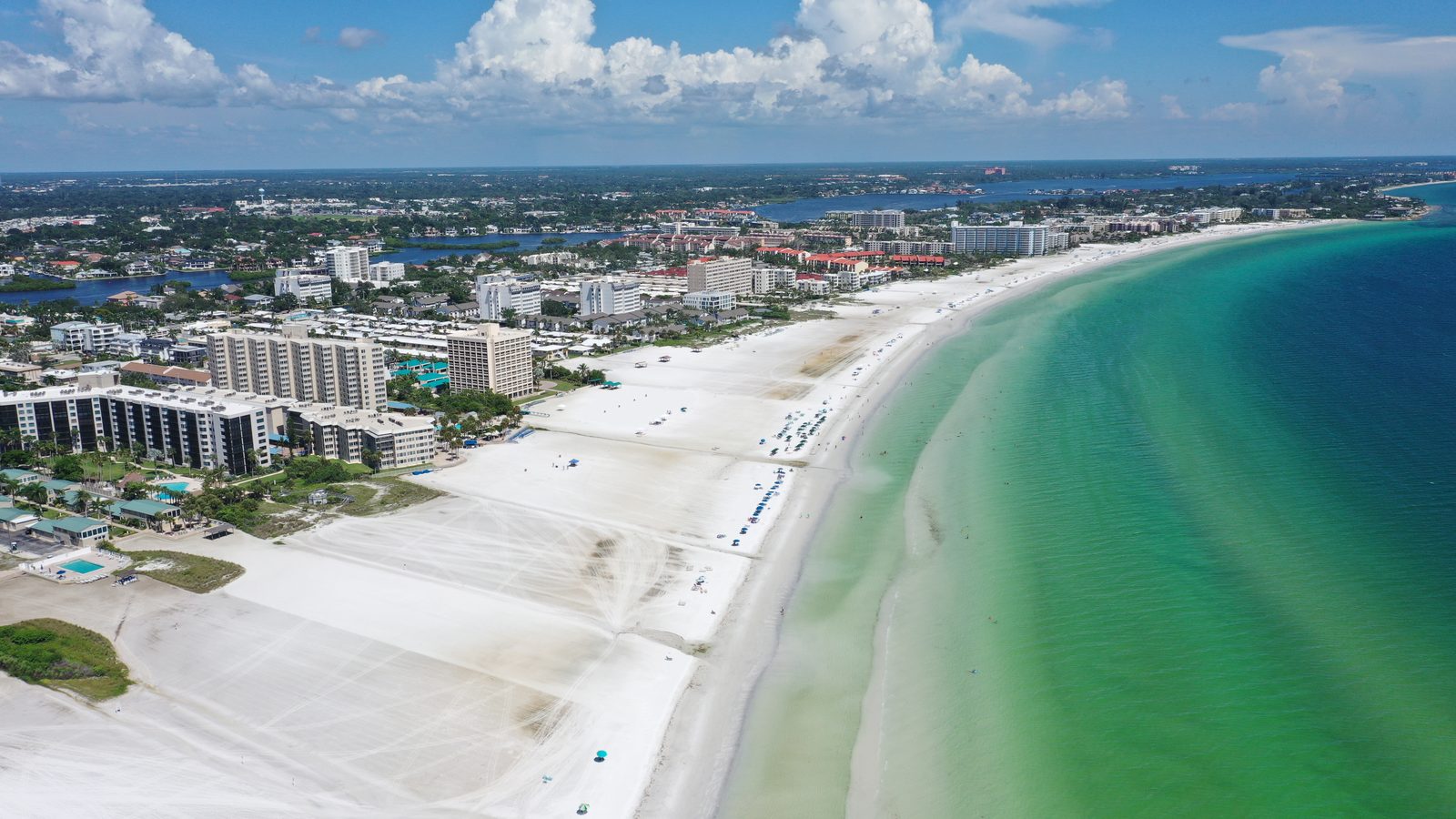 The white quartz shoreline of Siesta Key curving north past Gulf & Bay Club